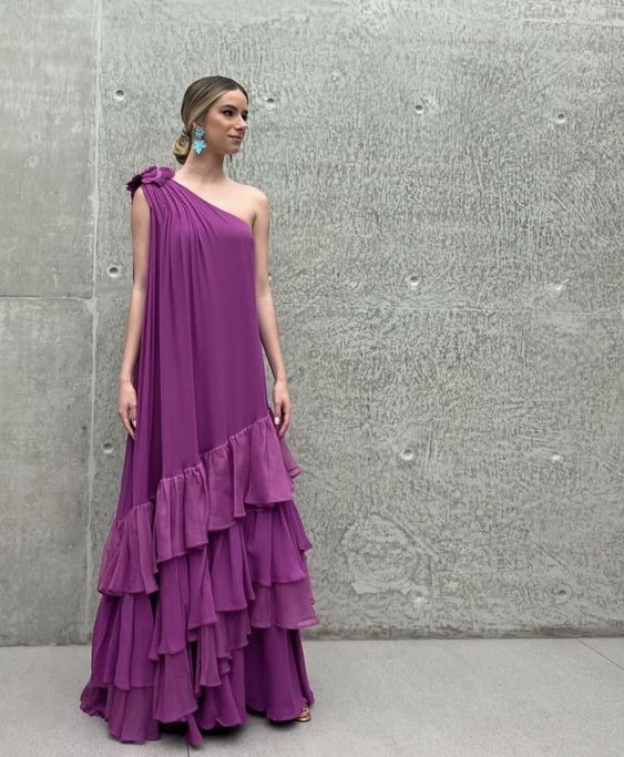 Model wearing an elegant one-shoulder ruffled chiffon prom dress in a studio setting.