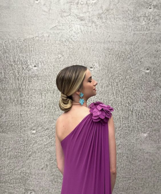Close-up of the ruffled one-shoulder detail on the chiffon prom dress.