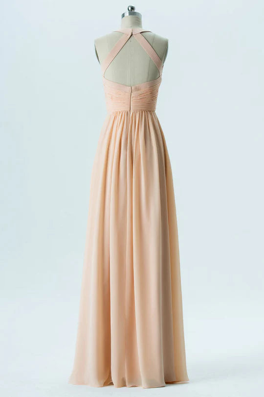 Back view of a woman wearing a light orange chiffon backless halter neck bridesmaid dress.
