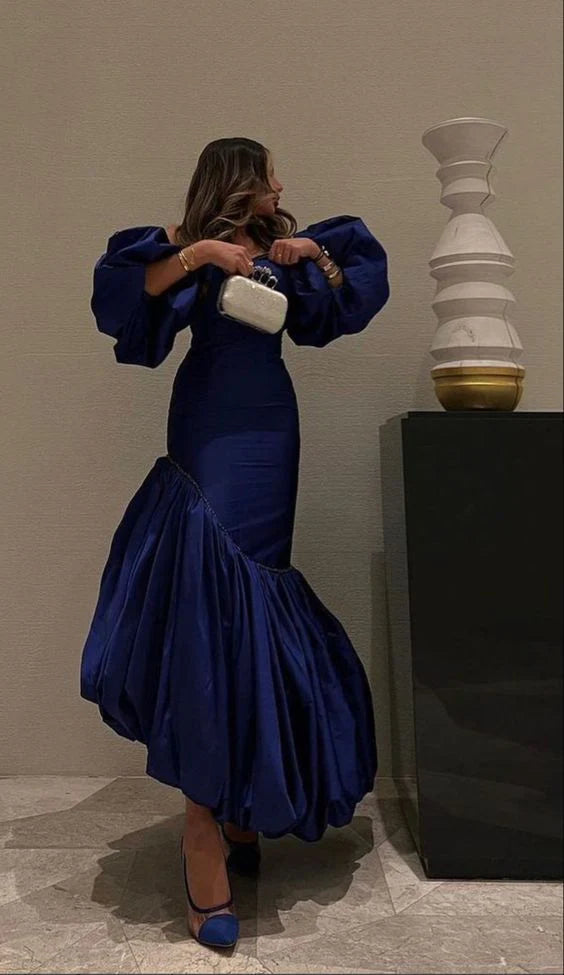 Woman wearing a classic fit off-shoulder satin blue evening dress.