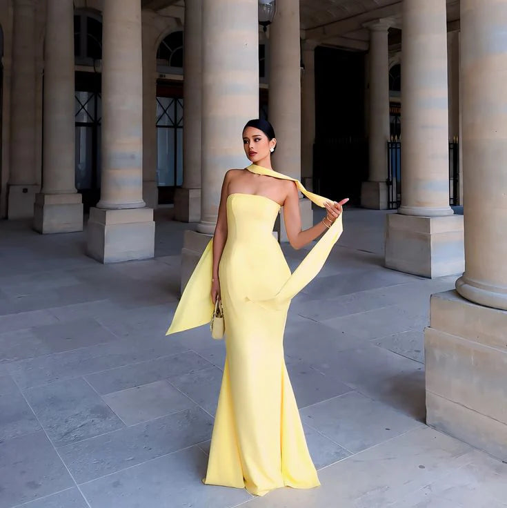 Back view of the elegant off-shoulder strapless mermaid evening gown, showing the train.