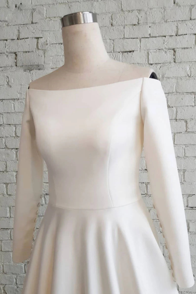 Model in a classic fit white satin long prom dress, side view.