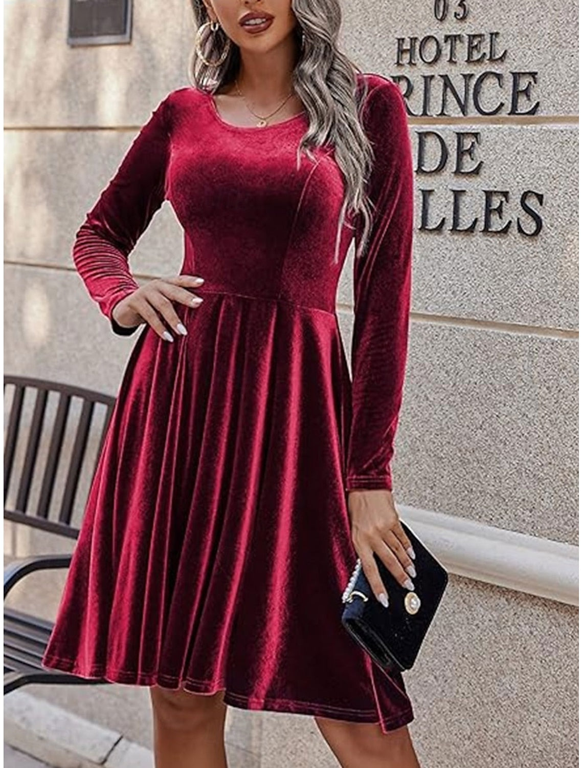 Woman in elegant black long-sleeve corset A-line bodycon midi dress.
