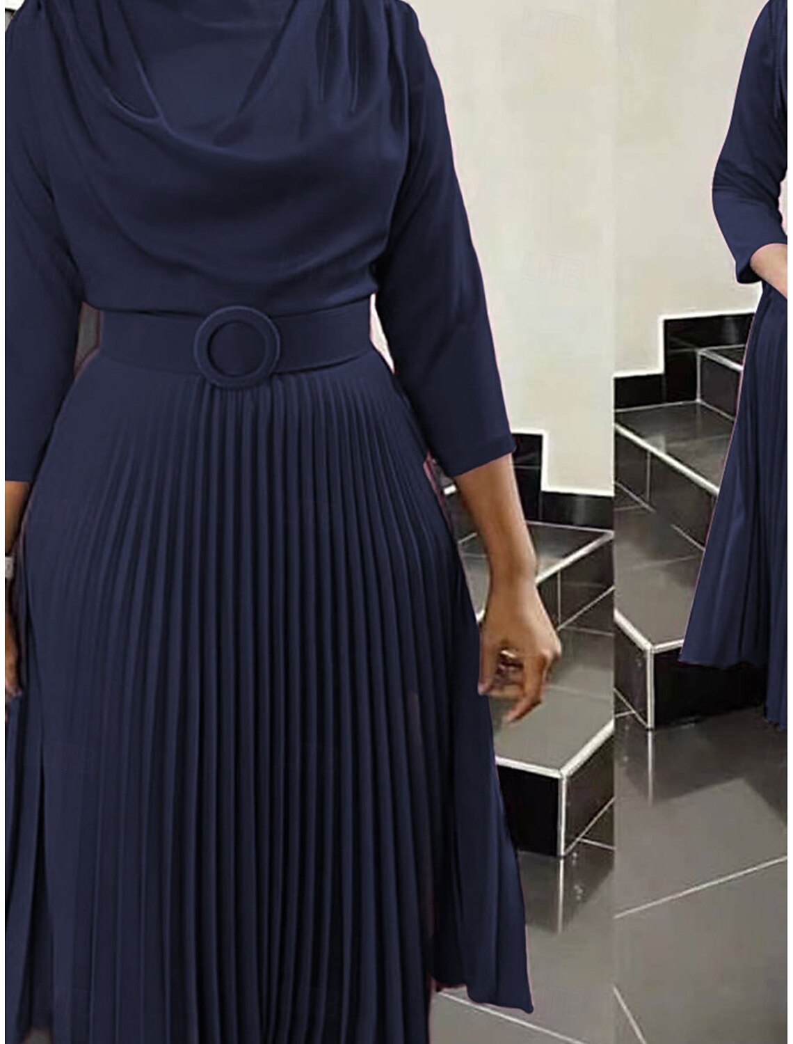 Woman wearing an elegant pink crew neck 3/4 sleeve belted maxi dress.