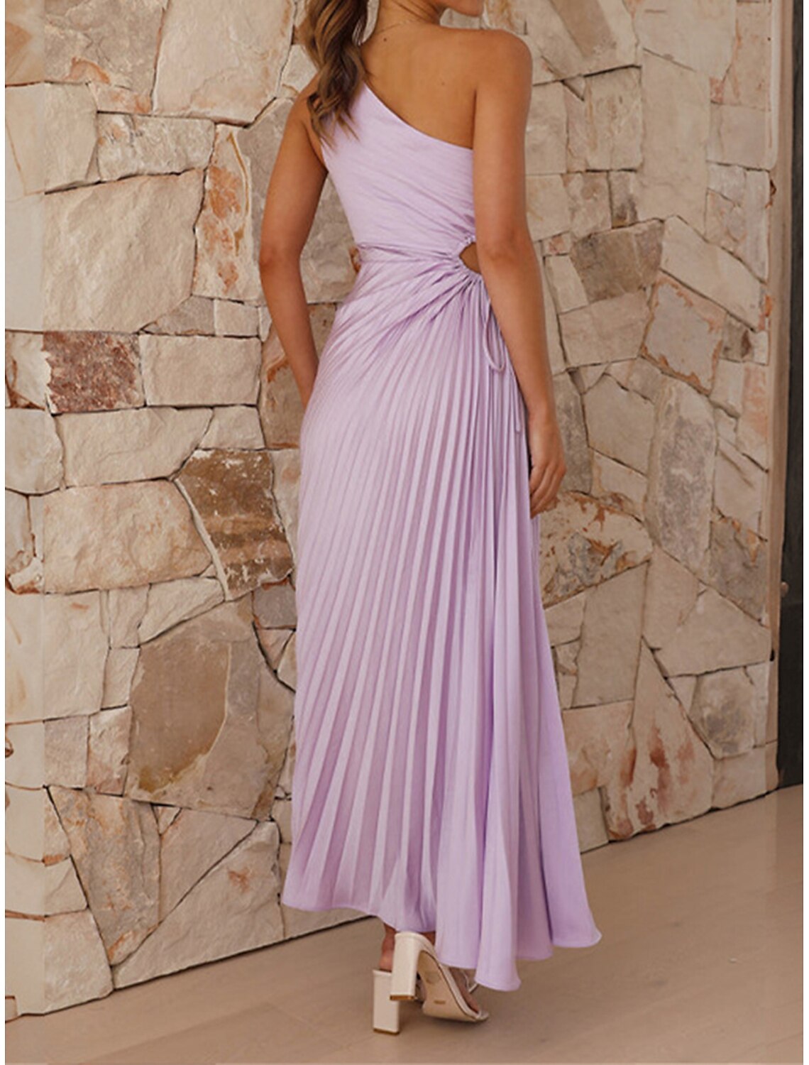 Side view of the purple one-shoulder pleated prom dress, showcasing the drawstring waist.