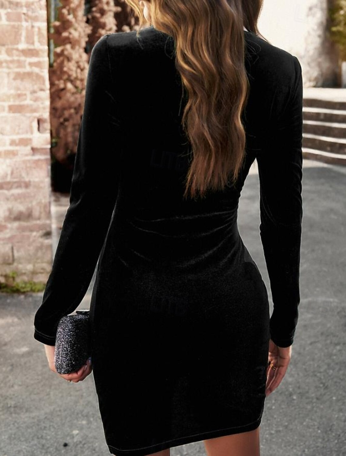 Close-up of the draped detail on the velvet bodycon long sleeve dress.