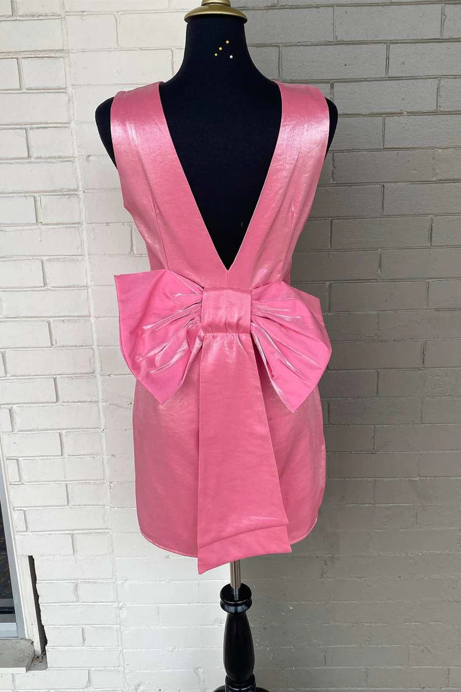 Side view of the bow-back short party dress, highlighting the fitted silhouette.