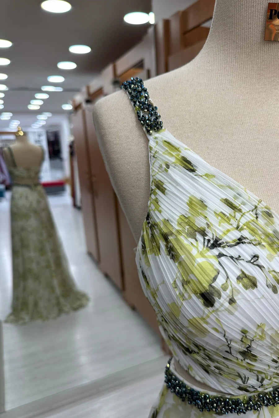 Side view of the floor-length floral print chiffon maxi dress.