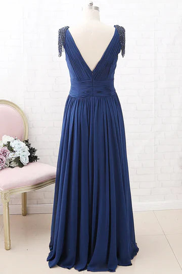 Side view of the navy blue chiffon dress with tassel sleeves.
