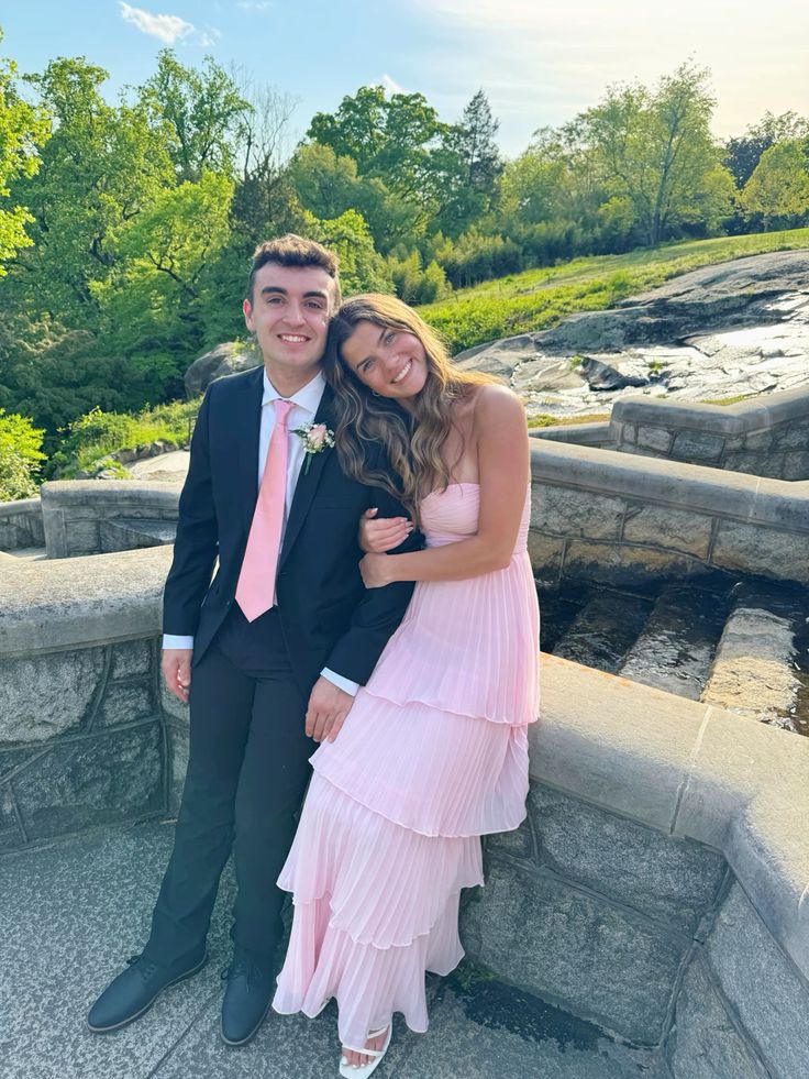 Side view of the model in the pink multi-layer chiffon prom dress, showing the flowy skirt.