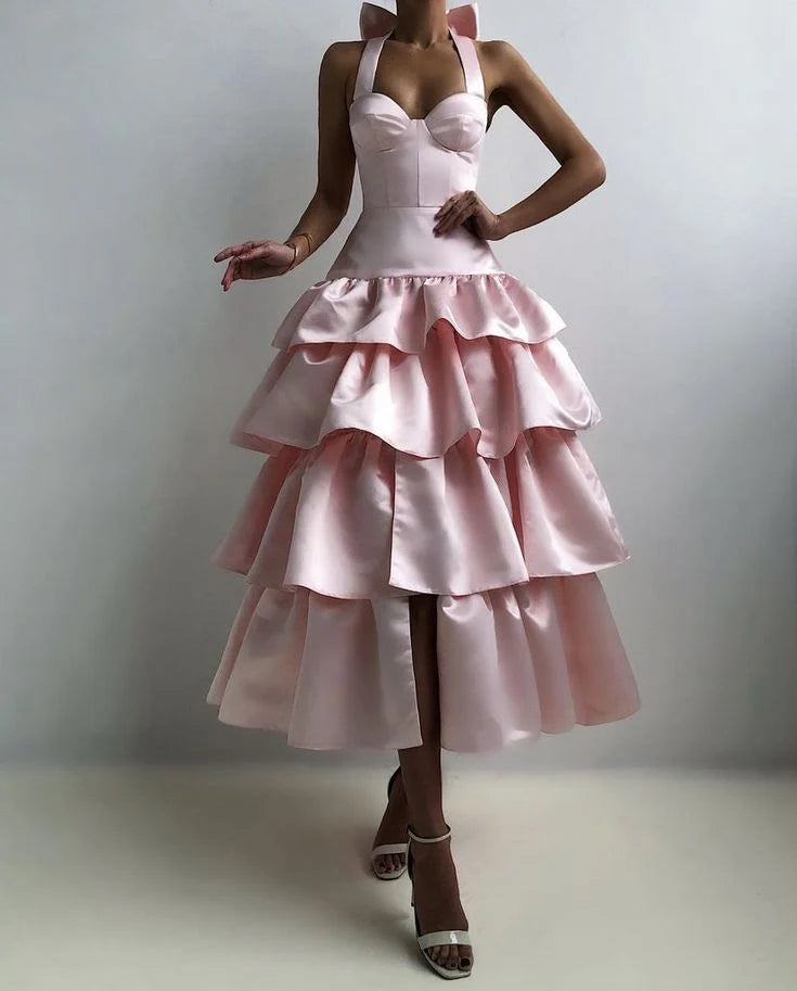 Model wearing an elegant pink sleeveless satin maxi evening dress.