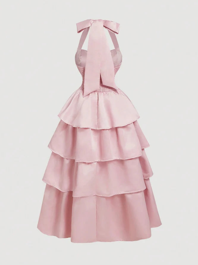 Side view of a woman in a flowing pink satin formal gown.