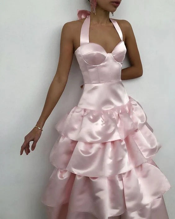 Close-up of the pink satin fabric and sleeveless neckline of the dress.
