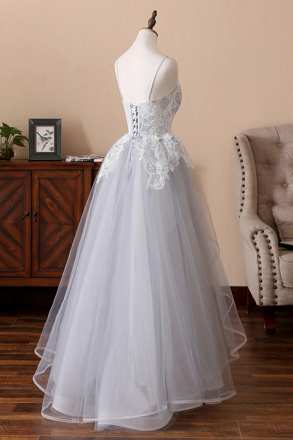 Back view of a gray long formal dress, highlighting the tulle skirt.