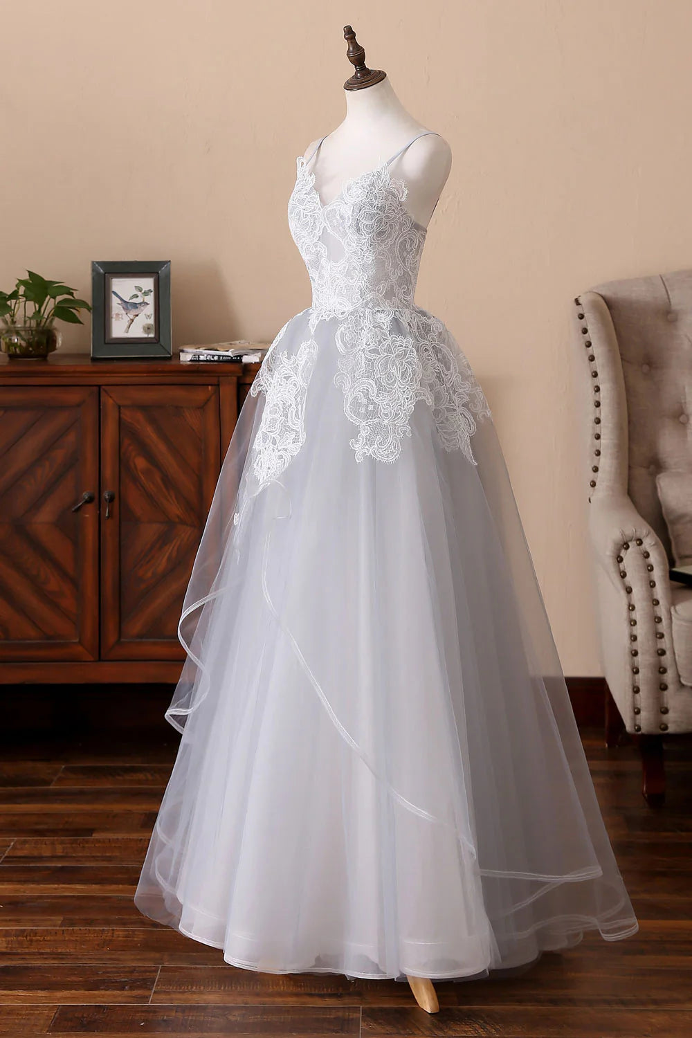 Close-up of the lace and waist detail on the gray prom dress.