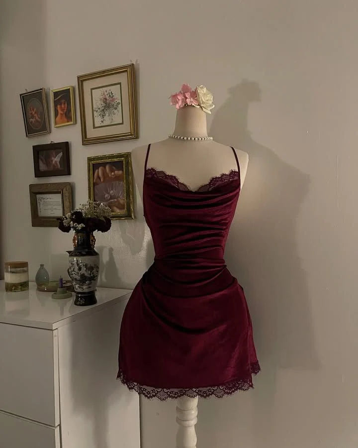 Model wearing a short burgundy velvet pleated halter neck homecoming dress.