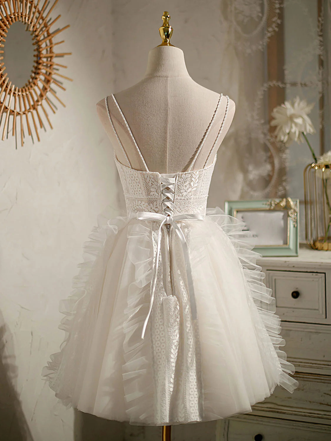 Side view of an ivory V-neck short homecoming dress, showcasing the lace bodice and flowing tulle skirt.