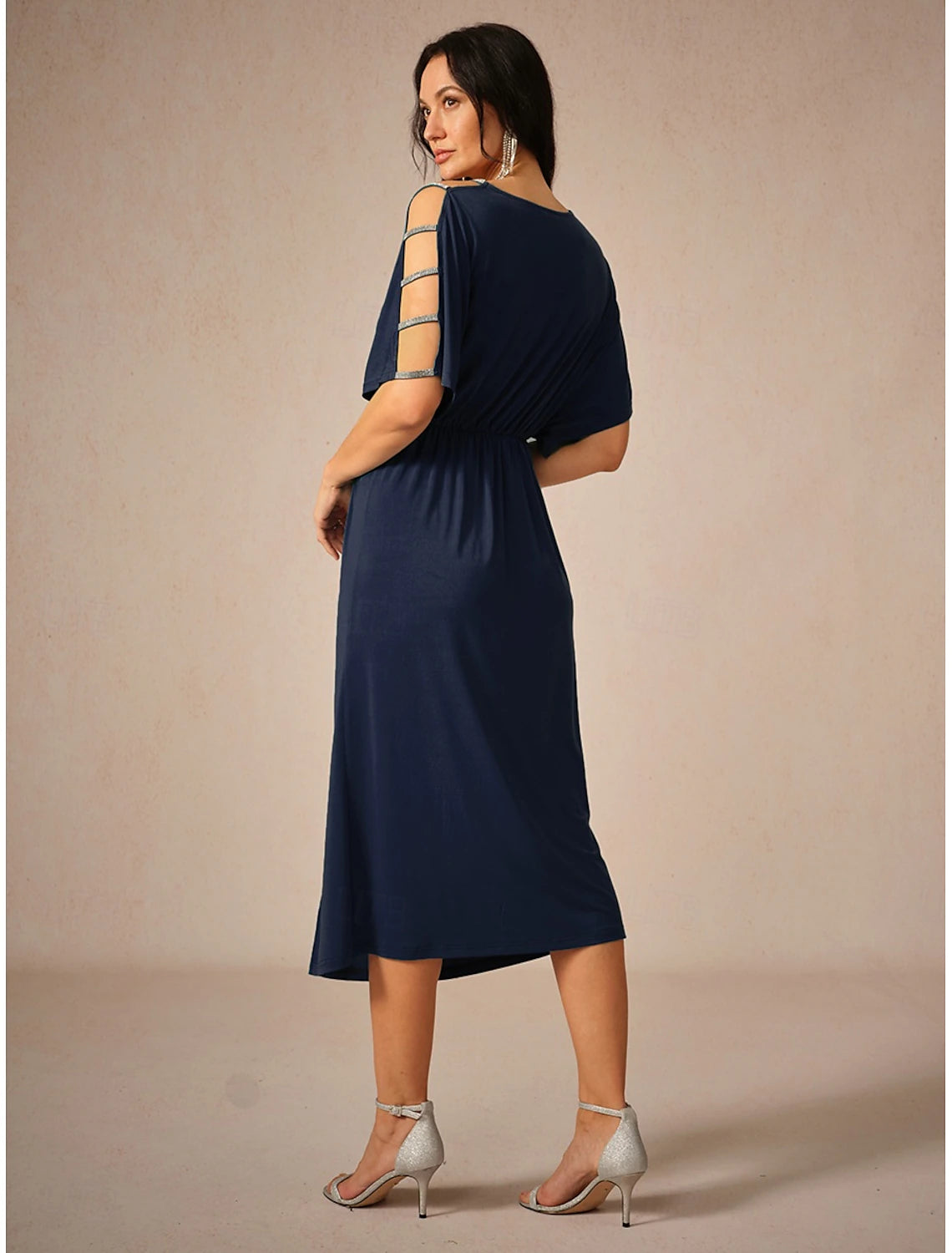 Back view of a woman wearing the navy blue knit midi dress.
