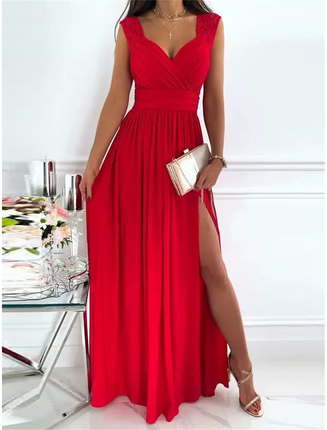 Side view of a woman in a lace ruched V-neck sleeveless dress.
