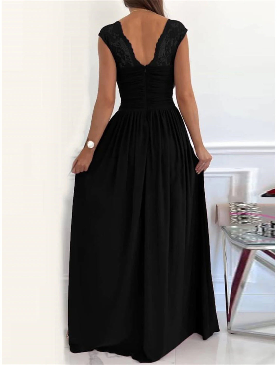 Woman posing in a flattering lace ruched V-neck prom dress.