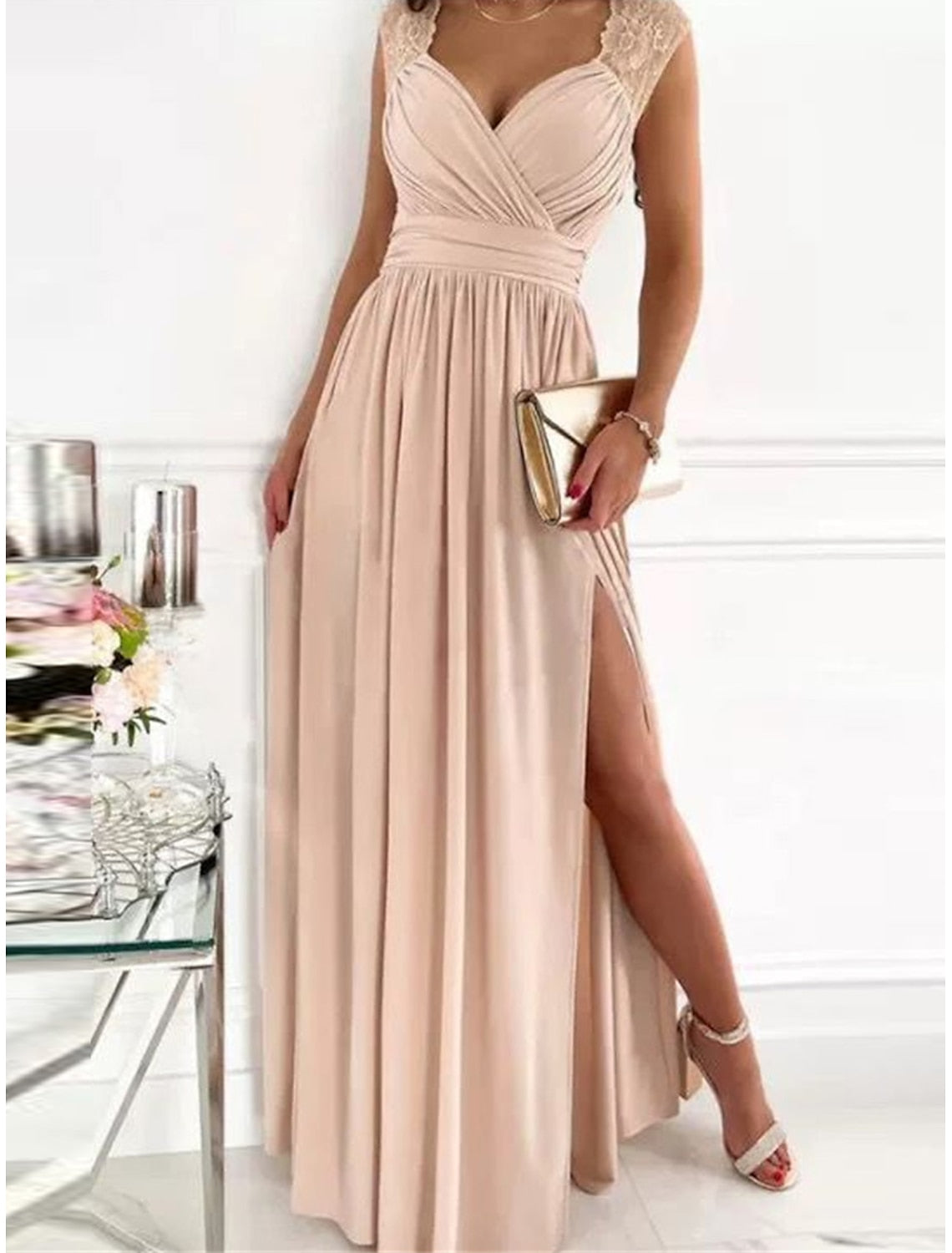 Woman showcasing the elegant V-neckline of the ruched dress.