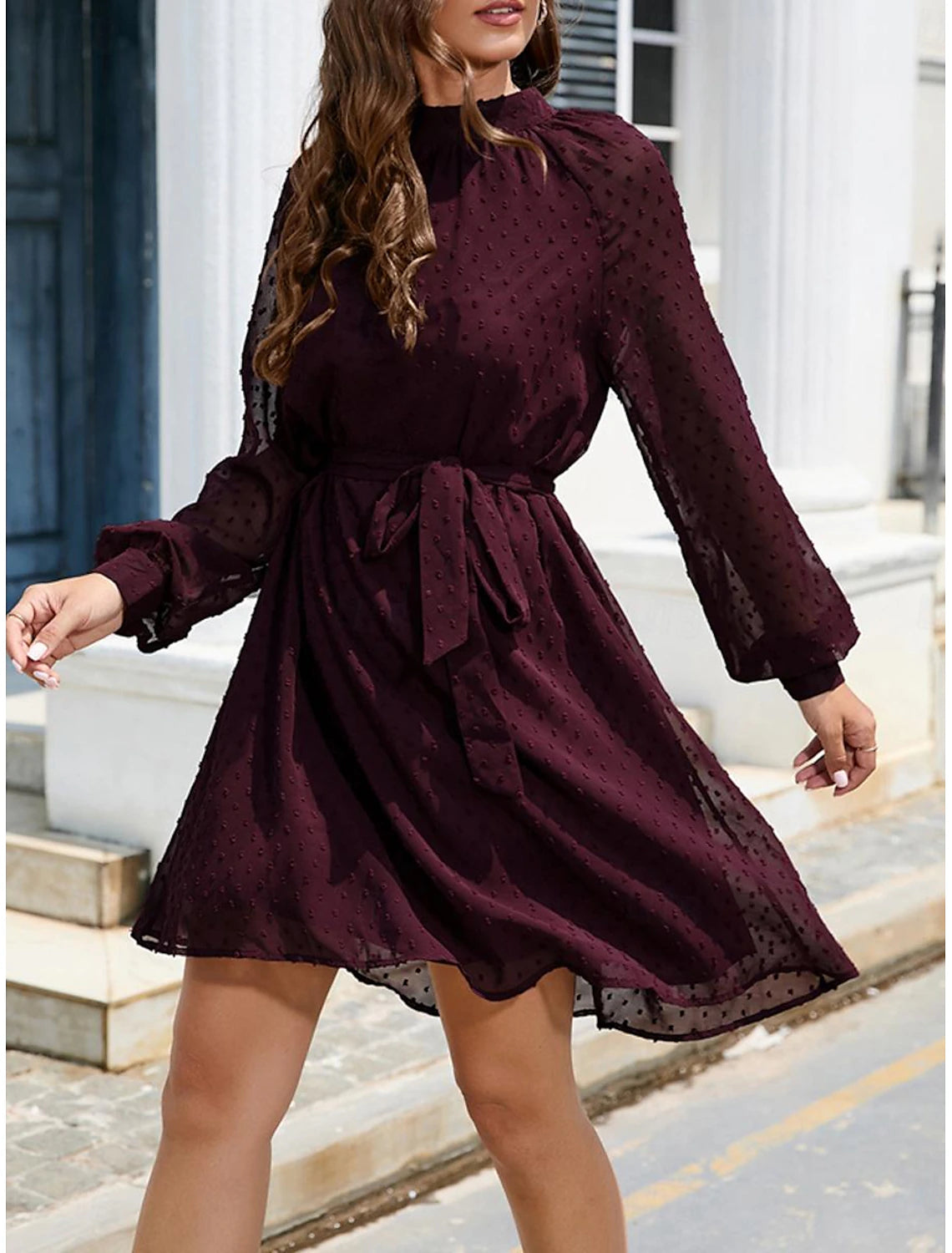 Side view of the model in the elegant chiffon mini dress, showing the lace-up detail.