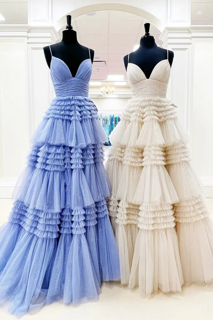 Woman in a light blue layered tulle A-line V-neck evening dress.