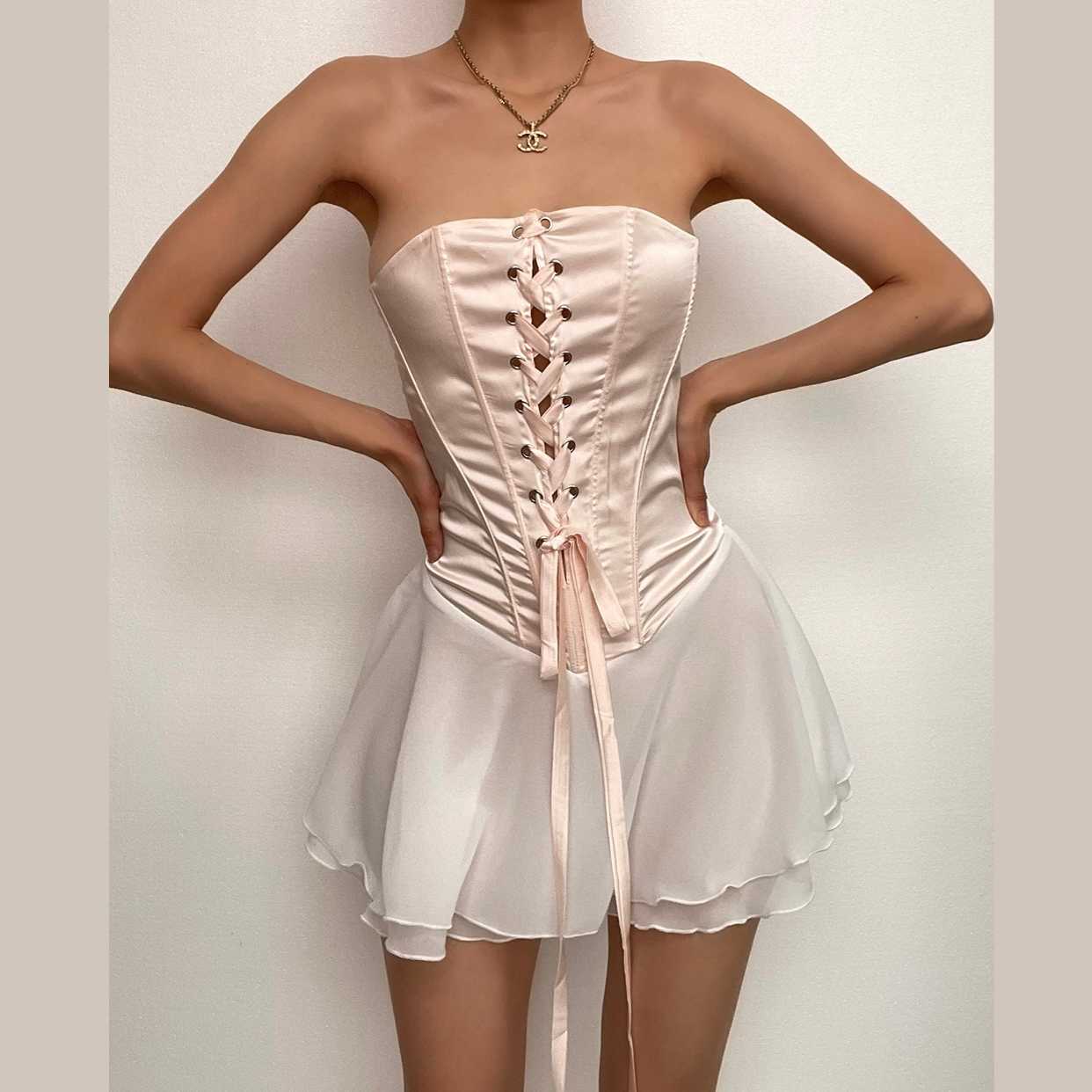 Elegant light pink A-line mini homecoming dress with strapless sweetheart neckline and ruffled skirt.