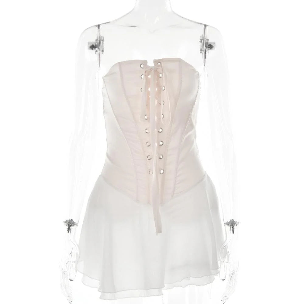 Side profile of the light pink strapless A-line dress with ruffled hem.