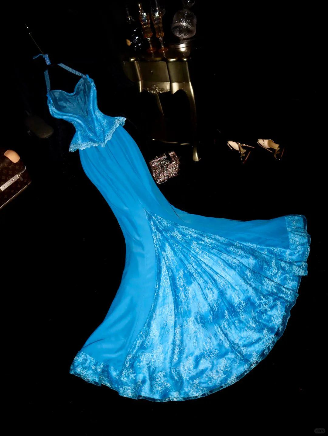 Back view of a blue mermaid halter dress with intricate sequin detailing.