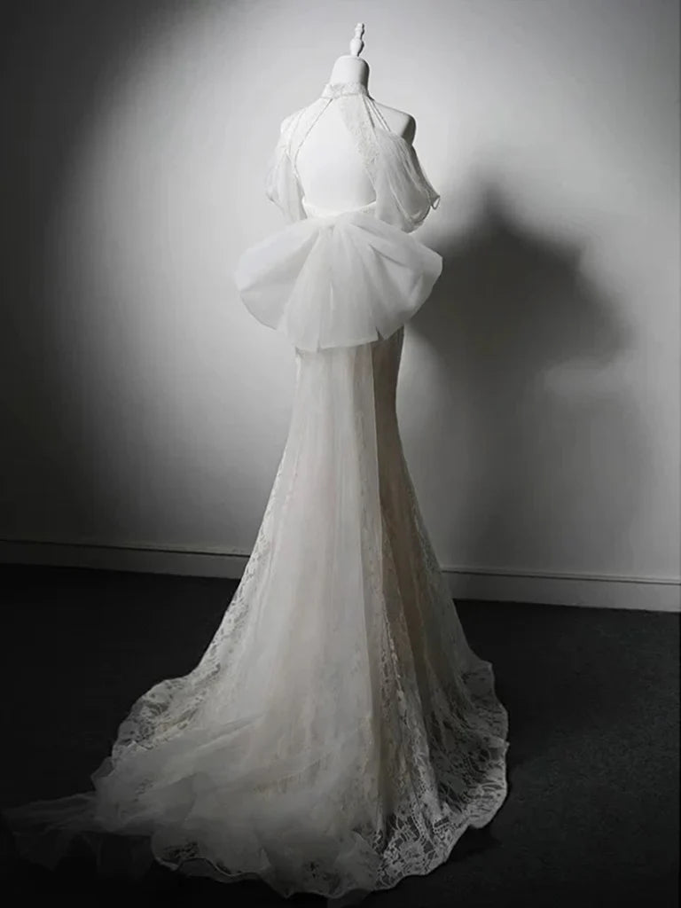 Back view of a model in a white mermaid high neck lace long prom evening gown.
