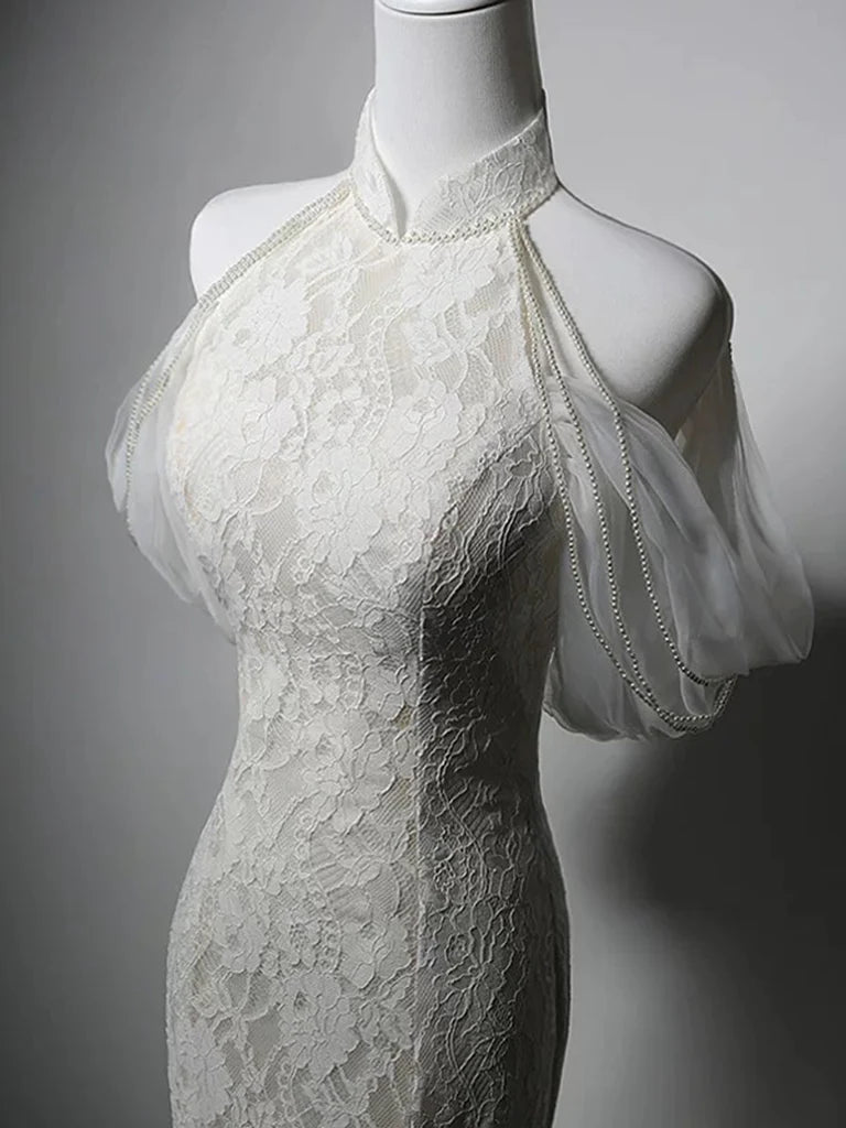 Close-up of the lace detail on the white mermaid high neck prom evening gown.