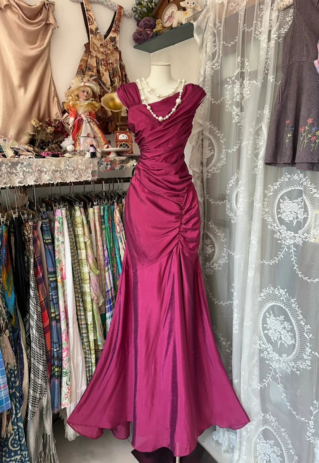 Elegant mermaid long evening gown in a rich red hue with a distinctive rose red folded design.