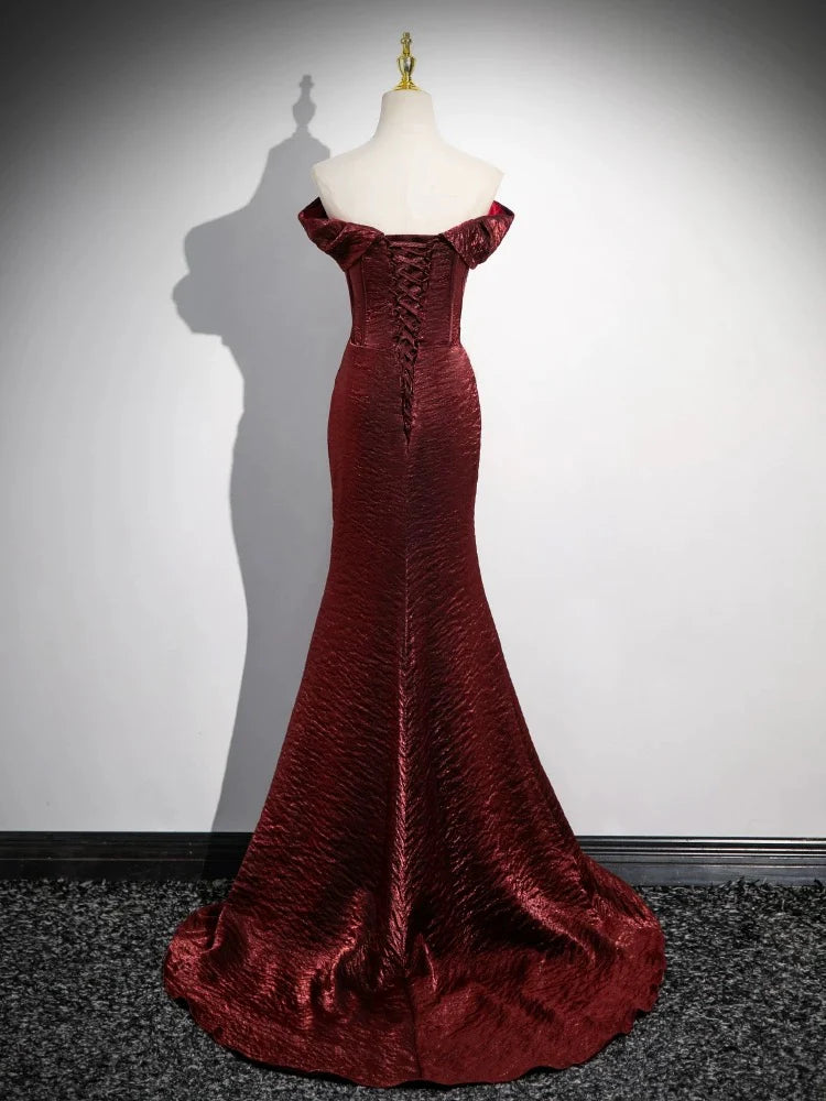 Back view of the elegant burgundy satin mermaid formal dress on a model.