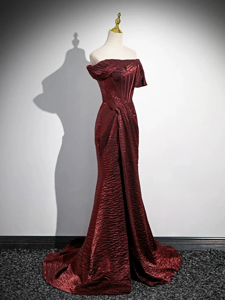 Side profile of a model in the burgundy off-shoulder evening gown.