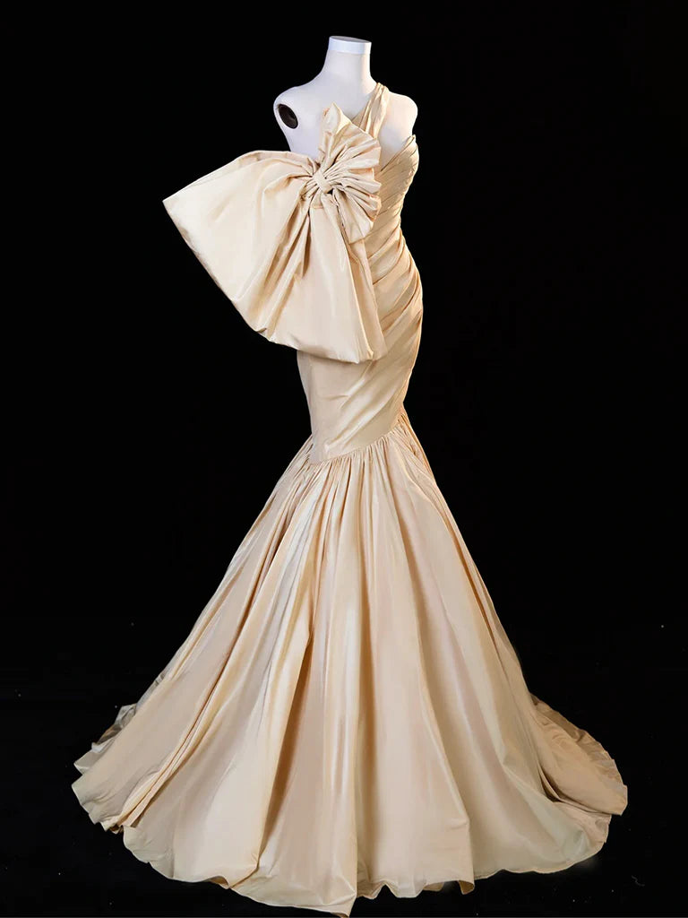 Elegant woman in a champagne mermaid satin long prom dress.
