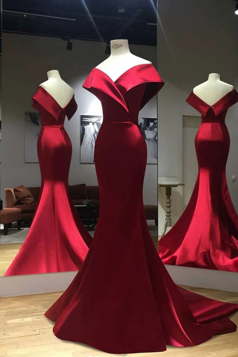 Elegant woman wearing a long red satin mermaid prom dress.