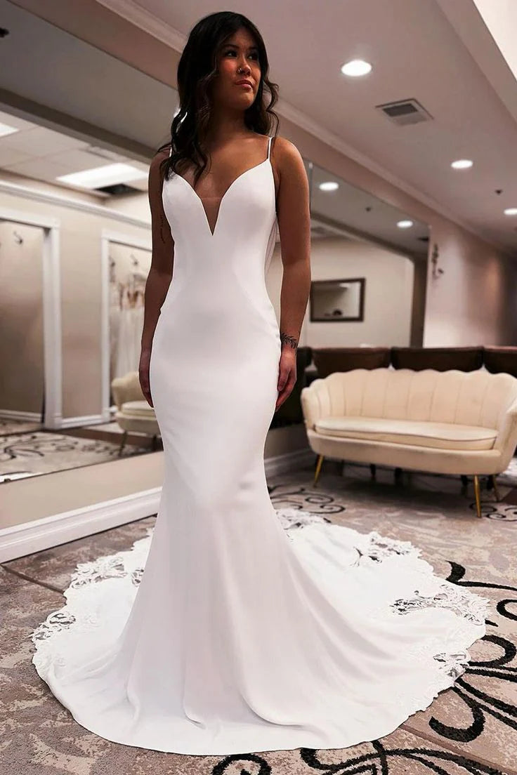 Side view of a mermaid satin wedding dress, highlighting the V-neck and applique details.