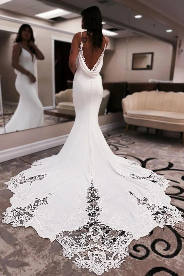 Back view of the mermaid wedding gown, showcasing the elegant train and satin fabric.