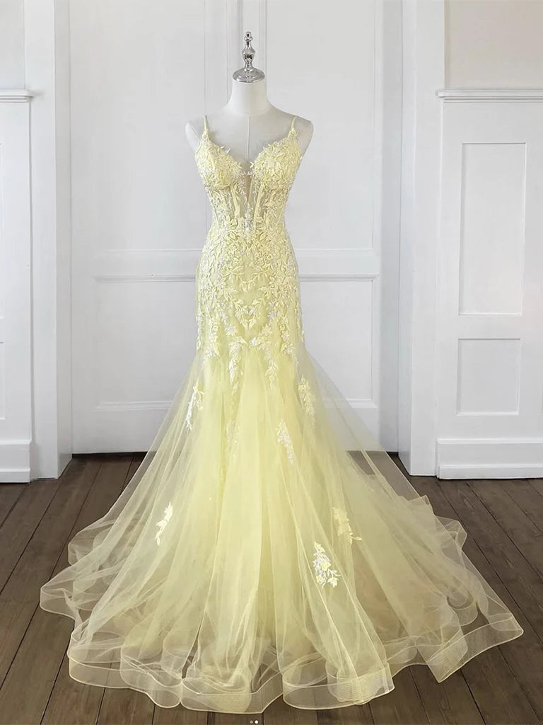 Woman wearing a yellow mermaid V-neck tulle lace long prom dress.