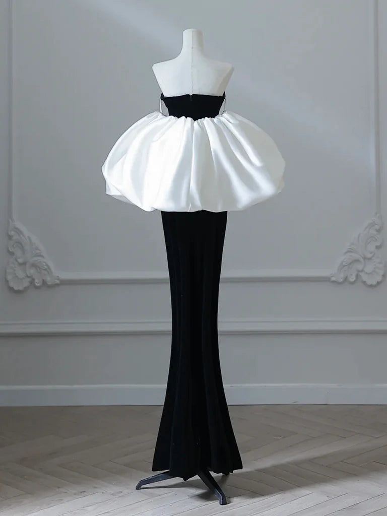 Model wearing a black velvet mermaid long prom dress, back view.