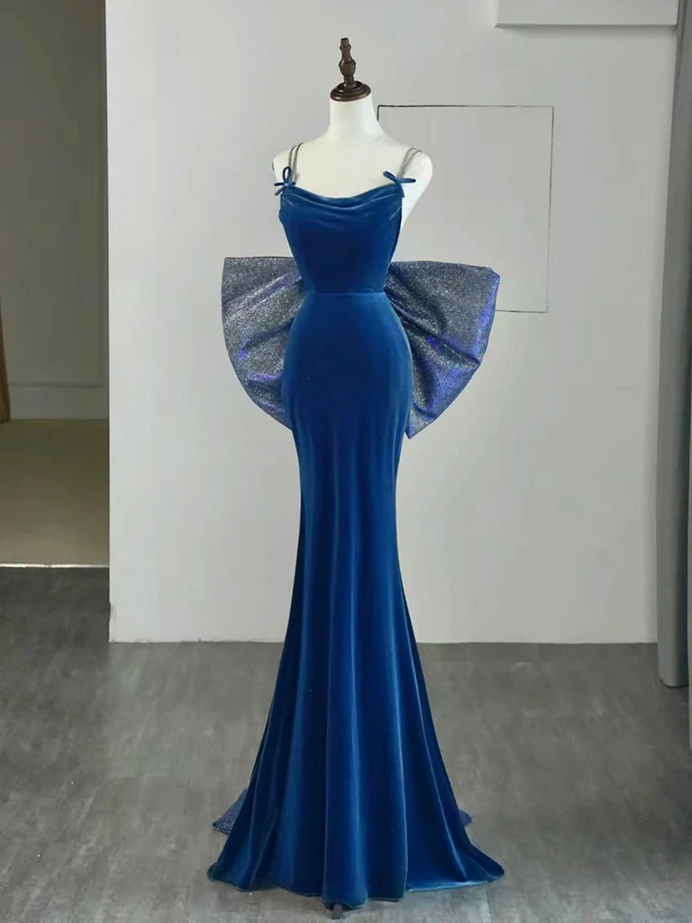 Woman wearing an elegant blue velvet mermaid long prom dress.