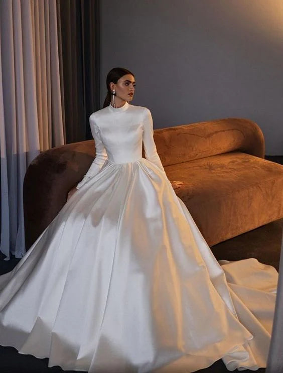 Model wearing an elegant A-line high neck satin boho wedding dress with long sleeves.