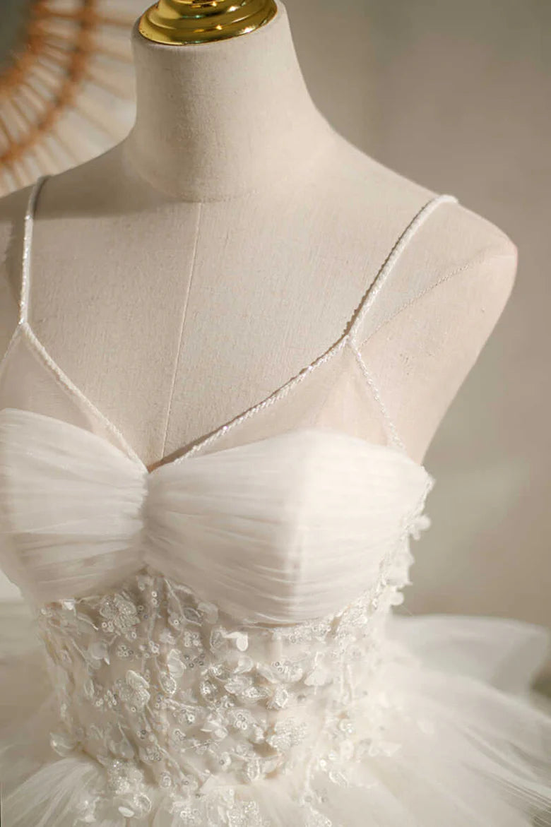 Back view of white multi-tiered tulle short party dress, highlighting lace-up detail.