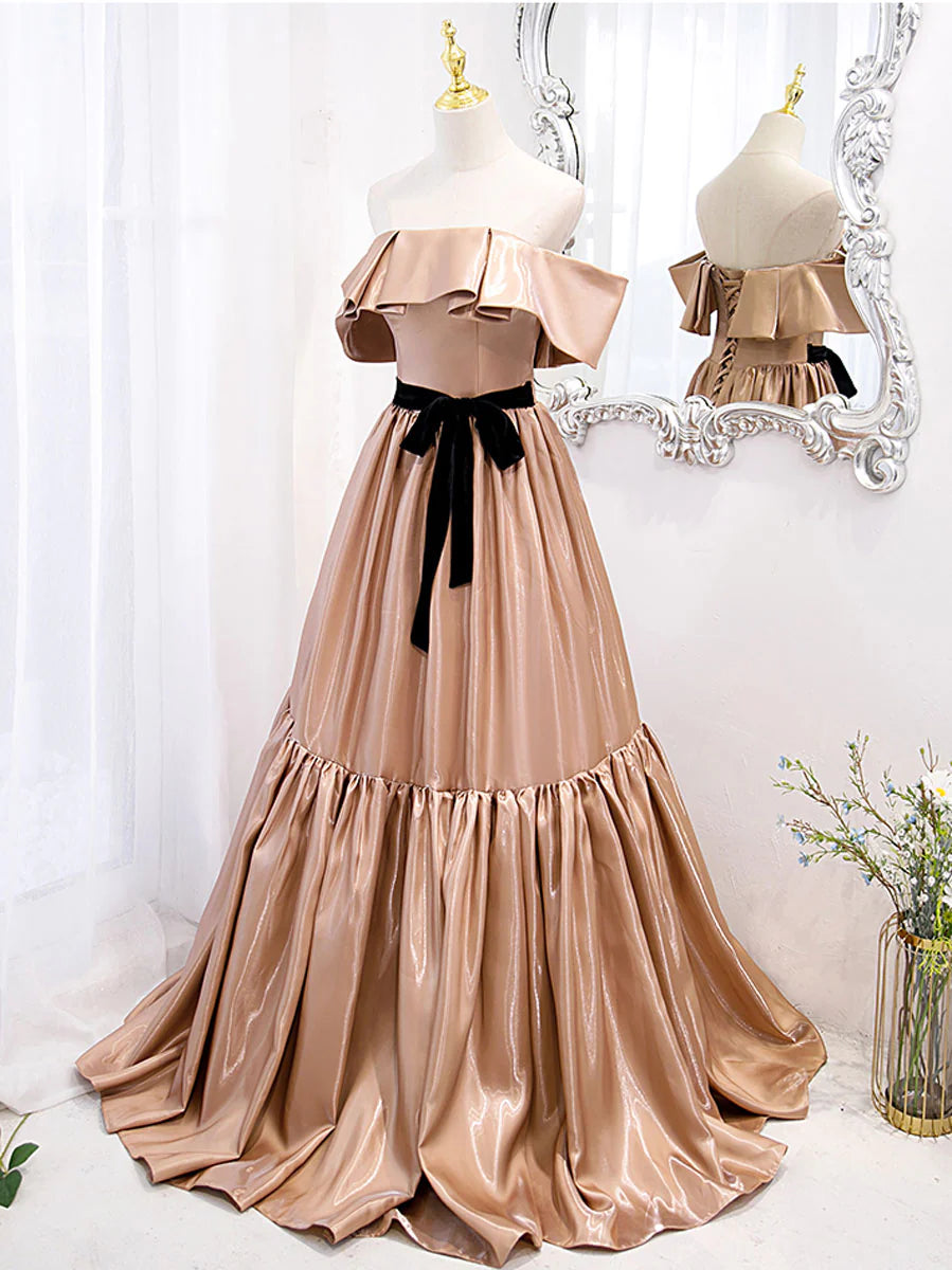 Back view of a woman in a champagne off-shoulder bridesmaid dress.