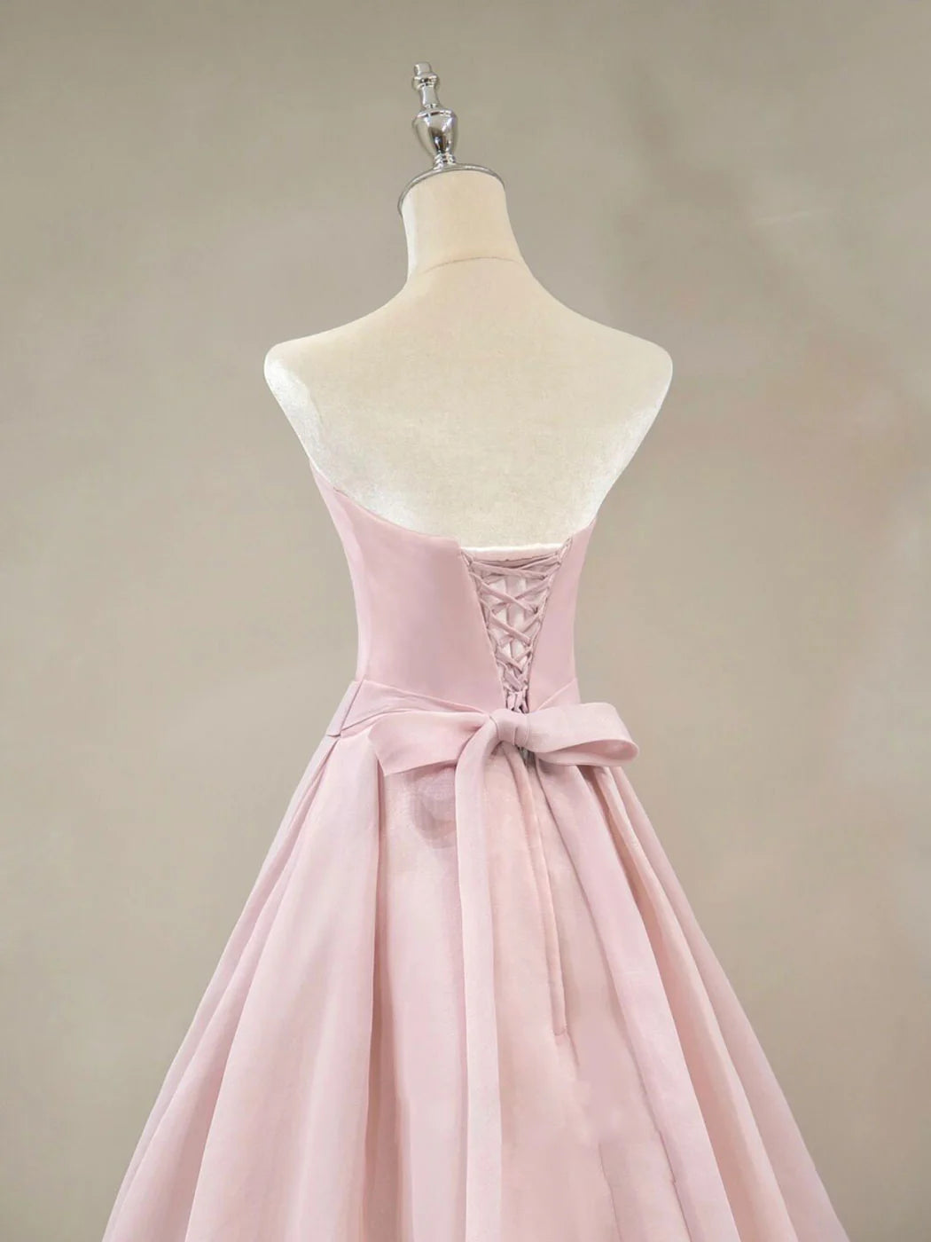 Back view of pink off-shoulder A-line long prom dress.