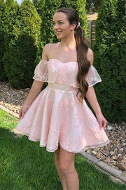 Model wearing an elegant off-shoulder pink lace short party dress, front view.