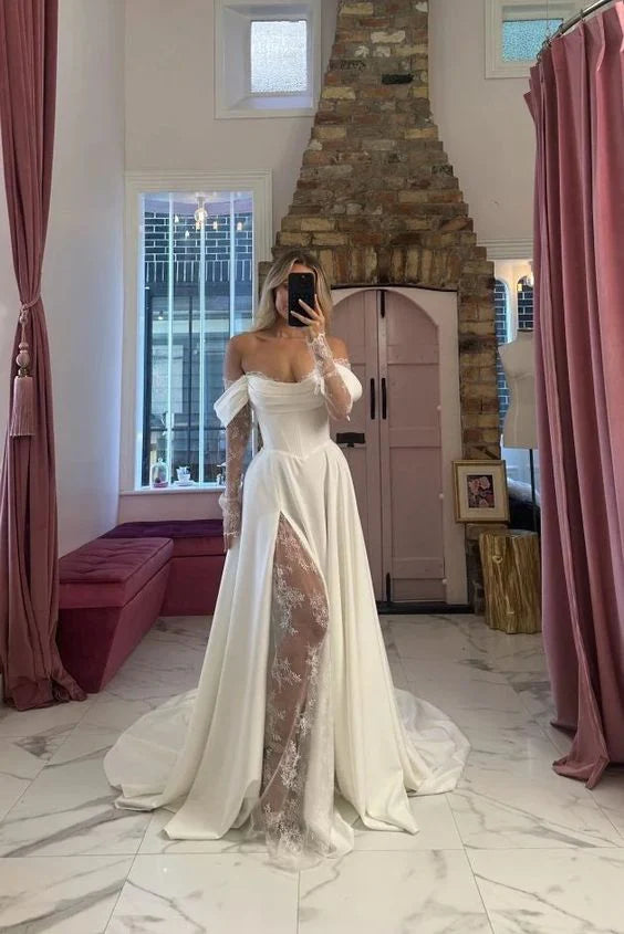 Bride wearing an elegant off-shoulder lace long sleeve wedding gown with a front slit.