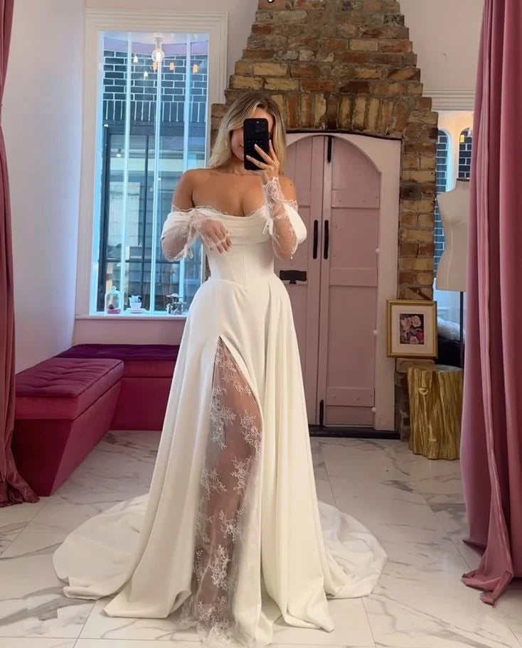 Side view of the off-shoulder lace long sleeve wedding gown, showing its flowing train.