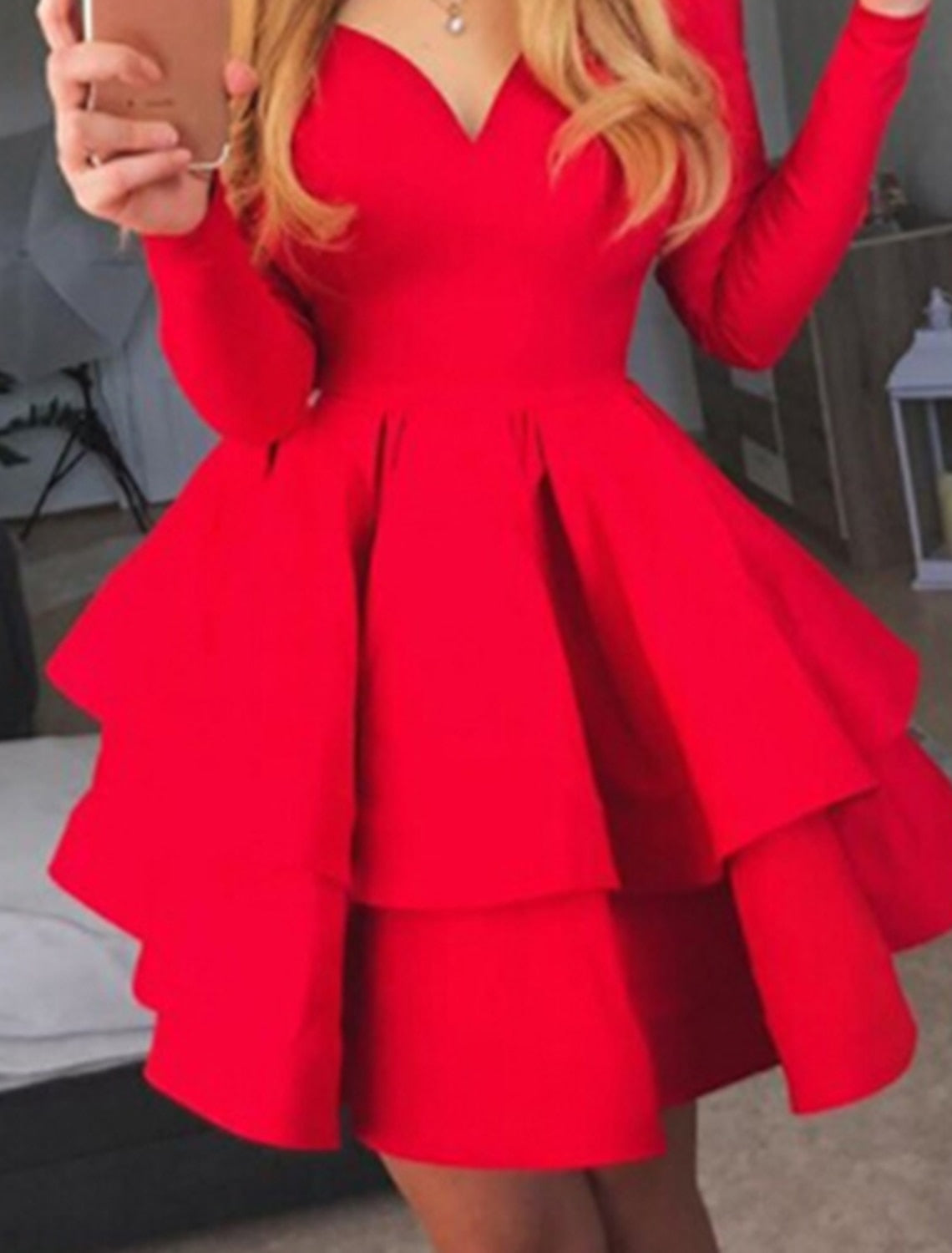 Woman in a pure color off-shoulder long sleeve party dress, side view highlighting waist pleats.